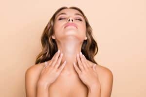 Woman with smooth neck after recovery from neck lift surgery.